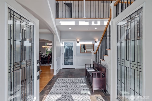 6817 Picnic Point Rd, Edmonds, WA 98026 - foyer with a decorative wall, french doors, stairs, stone finish flooring, and wainscoting