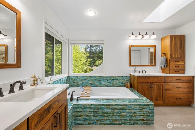 6817 Picnic Point Rd, Edmonds, WA 98026 - bathroom with two vanities, a garden tub, and a skylight