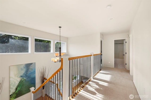 6817 Picnic Point Rd, Edmonds, WA 98026 - hallway with a chandelier, light carpet, and an upstairs landing