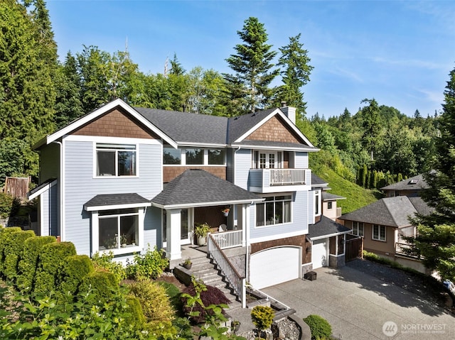 6817 Picnic Point Rd, Edmonds, WA 98026 - view of front of house with concrete driveway, roof with shingles, a chimney, a balcony, and a garage
