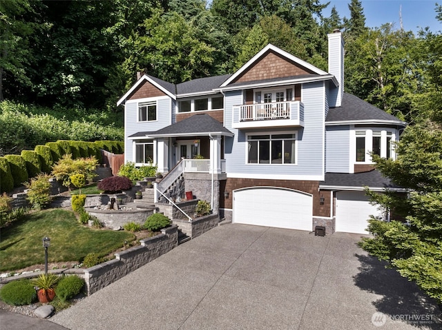 6817 Picnic Point Rd, Edmonds, WA 98026 - view of front of property with a balcony, an attached garage, concrete driveway, a chimney, and stone siding