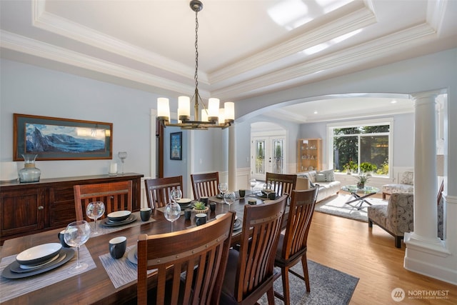 6817 Picnic Point Rd, Edmonds, WA 98026 - dining space with a tray ceiling, arched walkways, light wood-style floors, crown molding, and a chandelier