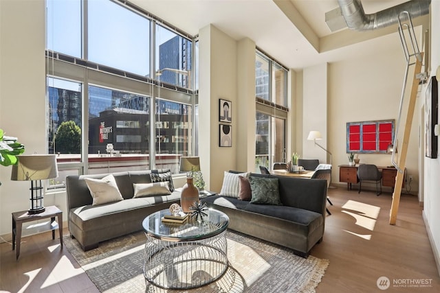 900 Lenora St Unit W106, Seattle, WA 98121 - living area featuring wood finished floors, a towering ceiling, and expansive windows