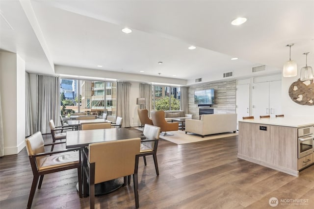 900 Lenora St Unit W106, Seattle, WA 98121 - dining room featuring a fireplace, healthy amount of natural light, recessed lighting, and dark wood finished floors