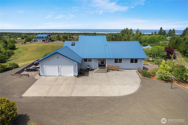 24 Jacalyn Ln, Grayland, WA 98547 - view of front of home featuring an attached garage, metal roof, and driveway