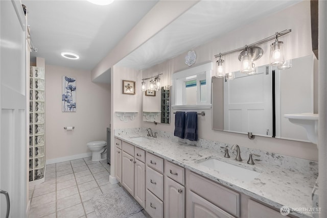 24 Jacalyn Ln, Grayland, WA 98547 - full bath featuring double vanity, toilet, baseboards, and tile patterned flooring
