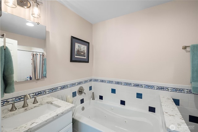 24 Jacalyn Ln, Grayland, WA 98547 - bathroom featuring vanity, a jetted tub, tile walls, and wainscoting