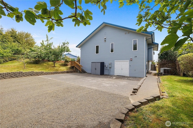 24 Jacalyn Ln, Grayland, WA 98547 - rear view of house featuring a lawn, central air condition unit, stairs, and a patio