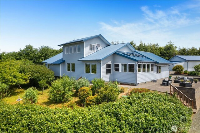 24 Jacalyn Ln, Grayland, WA 98547 - rear view of property with an outdoor living space, metal roof, and a patio area