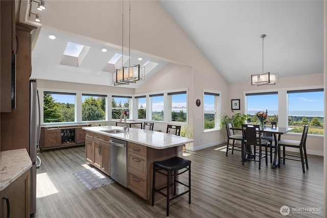 24 Jacalyn Ln, Grayland, WA 98547 - kitchen with a chandelier, dishwasher, a sink, high vaulted ceiling, and a skylight