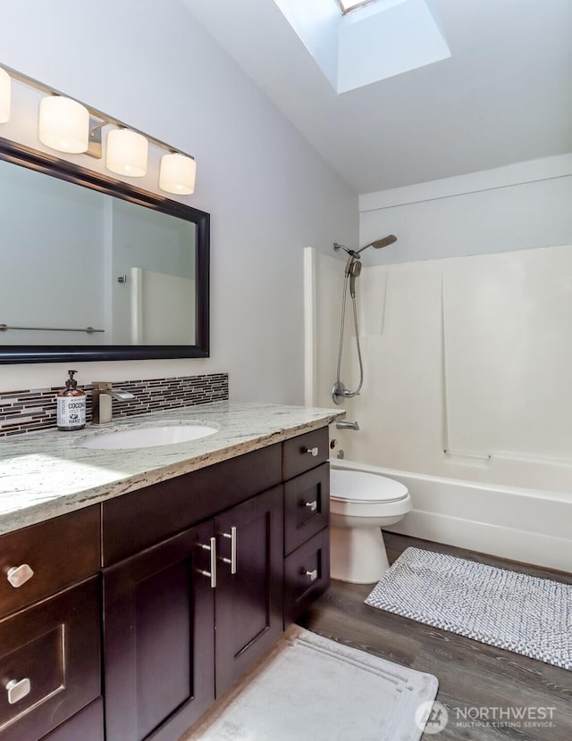 6002 35th Way SE, Auburn, WA 98092 - full bathroom featuring a skylight, vanity, shower / bath combination, wood finished floors, and tasteful backsplash