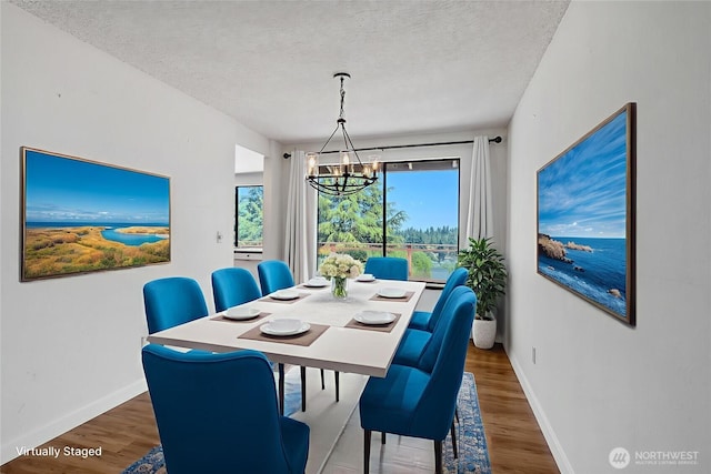 4026 SW 328th St, Federal Way, WA 98023 - dining area featuring a chandelier, wood finished floors, and a textured ceiling