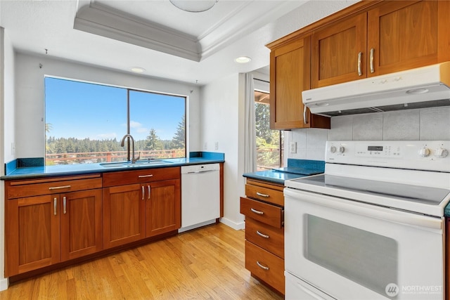 4026 SW 328th St, Federal Way, WA 98023 - kitchen featuring white appliances, under cabinet range hood, crown molding, light wood-type flooring, and brown cabinets