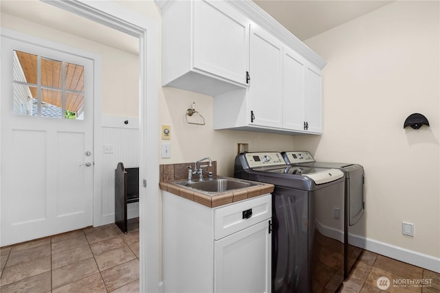 2575 Bretland Rd, Camano Island, WA 98282 - washroom with washing machine and clothes dryer, cabinet space, baseboards, and light stone finish floors