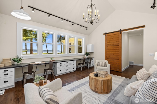 2575 Bretland Rd, Camano Island, WA 98282 - living area featuring rail lighting, a barn door, lofted ceiling, dark wood-style flooring, and a chandelier