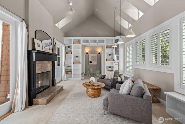 2575 Bretland Rd, Camano Island, WA 98282 - living room with high vaulted ceiling, carpet floors, a tile fireplace, and a skylight