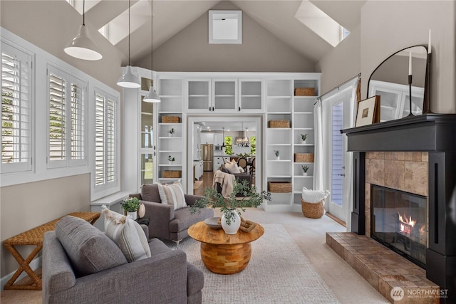 2575 Bretland Rd, Camano Island, WA 98282 - carpeted living area with high vaulted ceiling, a skylight, and a fireplace