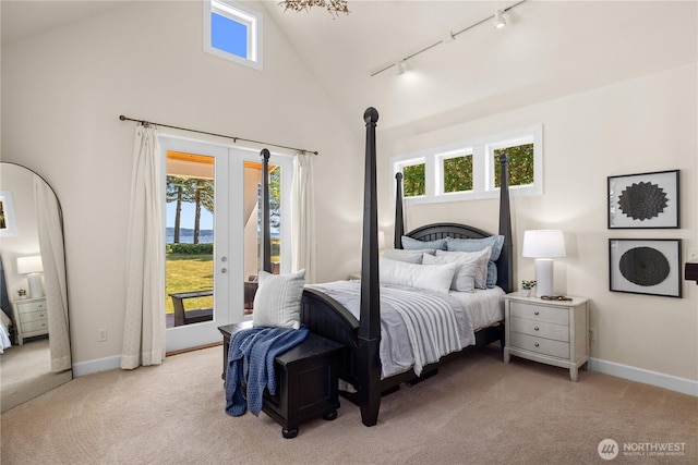 2575 Bretland Rd, Camano Island, WA 98282 - carpeted bedroom featuring rail lighting, access to outside, baseboards, and high vaulted ceiling