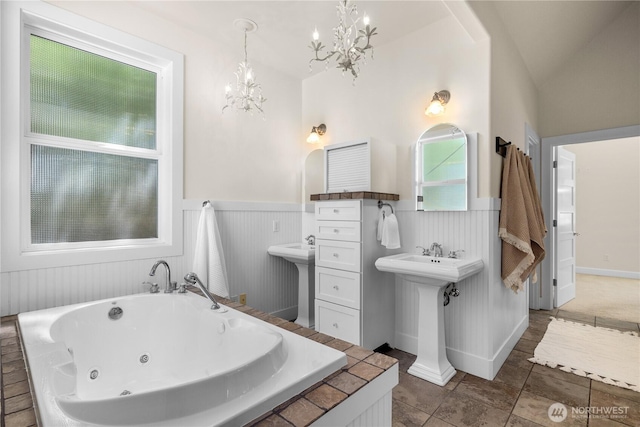 2575 Bretland Rd, Camano Island, WA 98282 - full bathroom featuring a chandelier, wainscoting, a tub with jets, a sink, and tile patterned floors