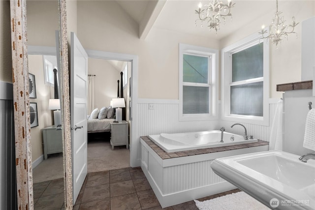 2575 Bretland Rd, Camano Island, WA 98282 - ensuite bathroom featuring wainscoting, a bath, and a chandelier