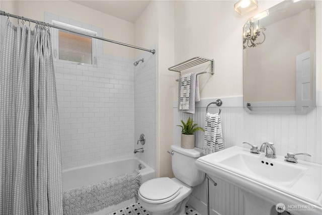 2575 Bretland Rd, Camano Island, WA 98282 - full bath with toilet, shower / tub combo with curtain, a wainscoted wall, and a sink