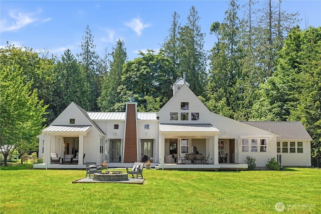 2575 Bretland Rd, Camano Island, WA 98282 - rear view of house with a fire pit, a chimney, and a yard