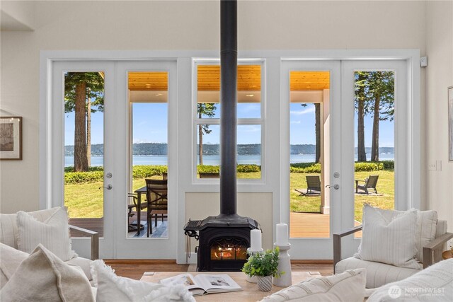 2575 Bretland Rd, Camano Island, WA 98282 - living area featuring a wood stove, a water view, healthy amount of natural light, and french doors