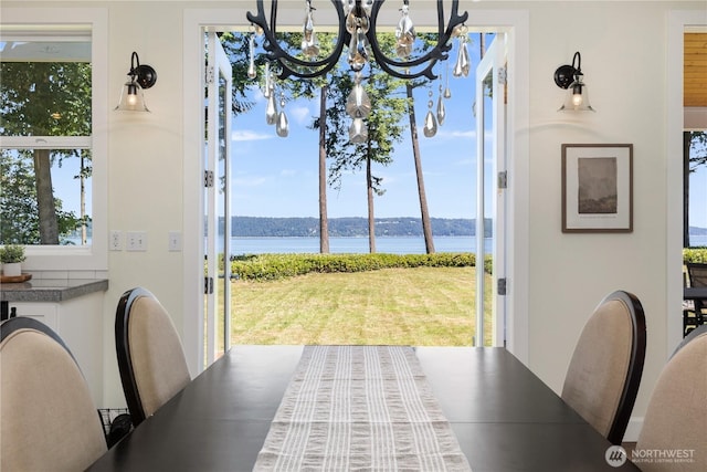 2575 Bretland Rd, Camano Island, WA 98282 - dining room featuring a water view, healthy amount of natural light, and a chandelier