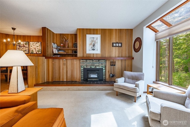 10500 Mt Baker Hwy Unit 905, Deming, WA 98244 - living room with wood walls, a chandelier, a wood stove, and carpet flooring