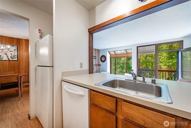10500 Mt Baker Hwy Unit 905, Deming, WA 98244 - kitchen with white appliances, healthy amount of natural light, light countertops, a textured ceiling, and brown cabinets