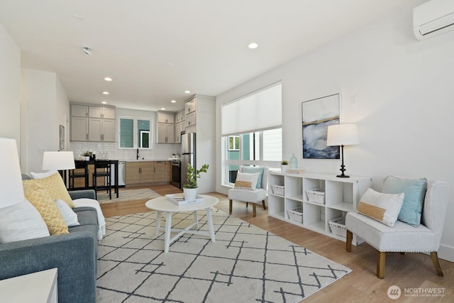 931 N 92nd St Unit B, Seattle, WA 98103 - living room with an AC wall unit, light wood-style flooring, and recessed lighting