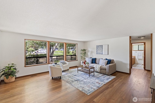1443 U St, Port Townsend, WA 98368 - living area featuring hardwood / wood-style flooring and a textured ceiling