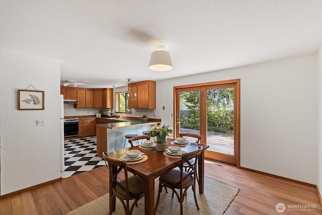 1443 U St, Port Townsend, WA 98368 - dining room with baseboards and light wood-style flooring