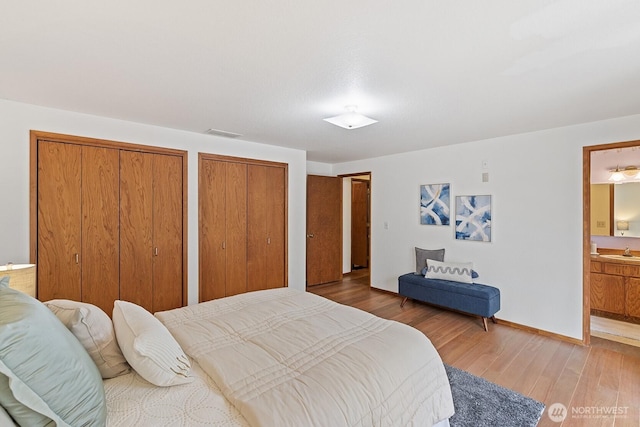 1443 U St, Port Townsend, WA 98368 - bedroom with two closets, light wood-type flooring, and connected bathroom