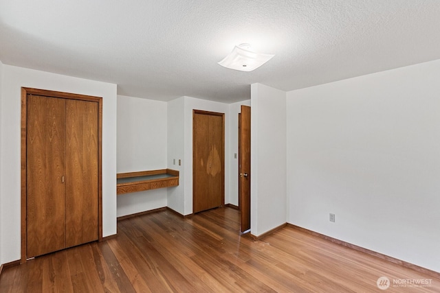 1443 U St, Port Townsend, WA 98368 - unfurnished bedroom with wood finished floors and a textured ceiling