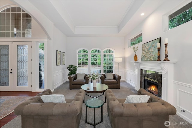7531 Hawkstone Ave SW, Port Orchard, WA 98367 - living area with a decorative wall, plenty of natural light, a high end fireplace, a tray ceiling, and recessed lighting
