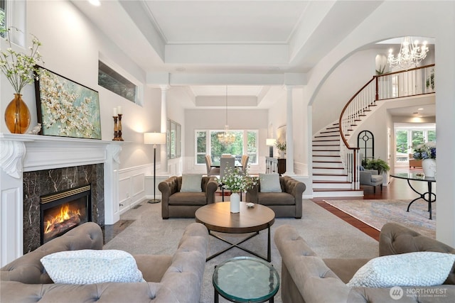7531 Hawkstone Ave SW, Port Orchard, WA 98367 - living room with a raised ceiling, a chandelier, plenty of natural light, stairway, and a decorative wall