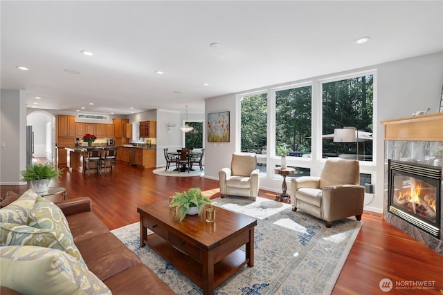 7531 Hawkstone Ave SW, Port Orchard, WA 98367 - living area with a fireplace, dark wood-style floors, recessed lighting, and arched walkways
