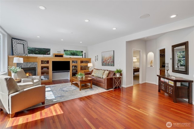 7531 Hawkstone Ave SW, Port Orchard, WA 98367 - living area featuring a premium fireplace, wood finished floors, recessed lighting, and baseboards
