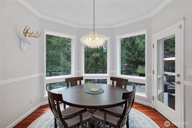 7531 Hawkstone Ave SW, Port Orchard, WA 98367 - dining area featuring a chandelier, dark wood finished floors, and crown molding