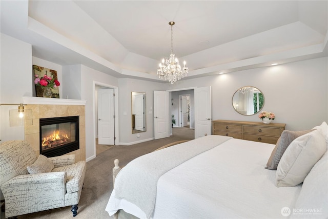 7531 Hawkstone Ave SW, Port Orchard, WA 98367 - carpeted bedroom with a tray ceiling, a fireplace, a chandelier, and baseboards