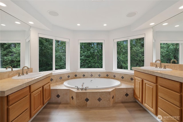 7531 Hawkstone Ave SW, Port Orchard, WA 98367 - bathroom featuring healthy amount of natural light, two vanities, a bath, and recessed lighting