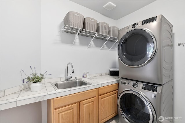 7531 Hawkstone Ave SW, Port Orchard, WA 98367 - laundry area featuring stacked washer and clothes dryer and cabinet space