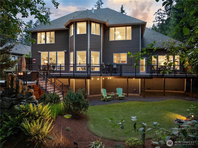 7531 Hawkstone Ave SW, Port Orchard, WA 98367 - rear view of property featuring stairway, a shingled roof, a lawn, and a deck