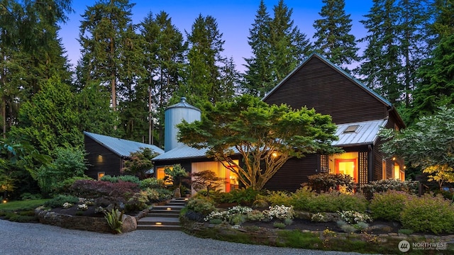 9000 NE Hidden Cove Rd, Bainbridge Island, WA 98110 - view of front facade featuring a standing seam roof, a metal roof, and stairway