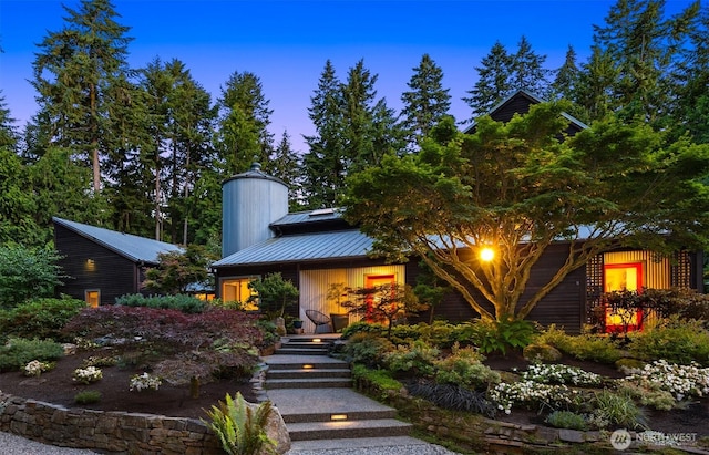 9000 NE Hidden Cove Rd, Bainbridge Island, WA 98110 - mid-century home with a metal roof, a chimney, and a standing seam roof