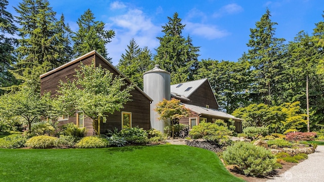 9000 NE Hidden Cove Rd, Bainbridge Island, WA 98110 - view of side of home with a lawn, a metal roof, and a chimney