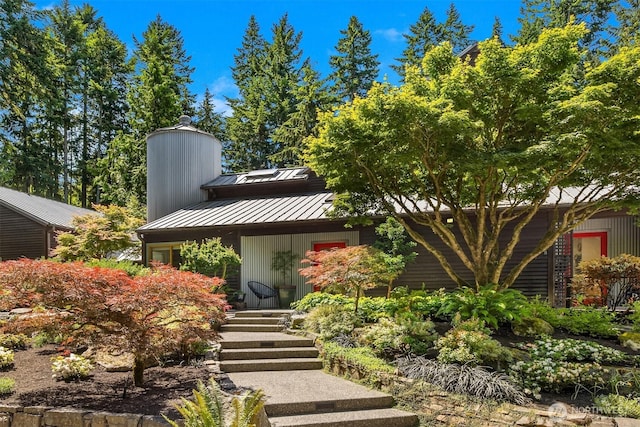 9000 NE Hidden Cove Rd, Bainbridge Island, WA 98110 - view of front facade featuring a standing seam roof, a metal roof, and a chimney