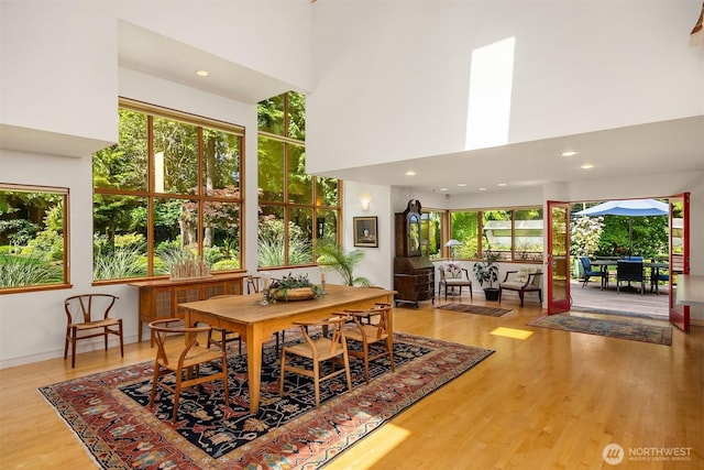 9000 NE Hidden Cove Rd, Bainbridge Island, WA 98110 - dining space featuring a high ceiling, wood finished floors, plenty of natural light, and recessed lighting