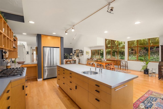 9000 NE Hidden Cove Rd, Bainbridge Island, WA 98110 - kitchen featuring stainless steel appliances, light countertops, light wood-type flooring, an island with sink, and recessed lighting
